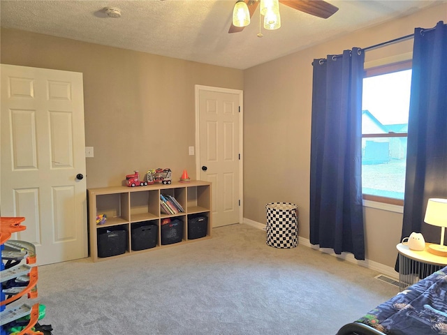 bedroom featuring a textured ceiling, multiple windows, carpet flooring, and baseboards