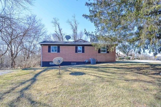 view of side of home featuring brick siding, a lawn, and cooling unit