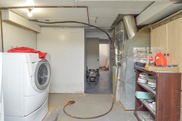 clothes washing area featuring washer / dryer and laundry area