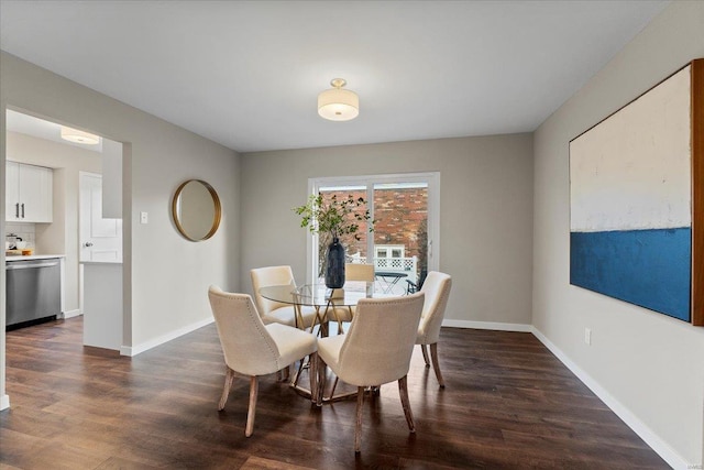 dining space featuring dark wood-style floors and baseboards