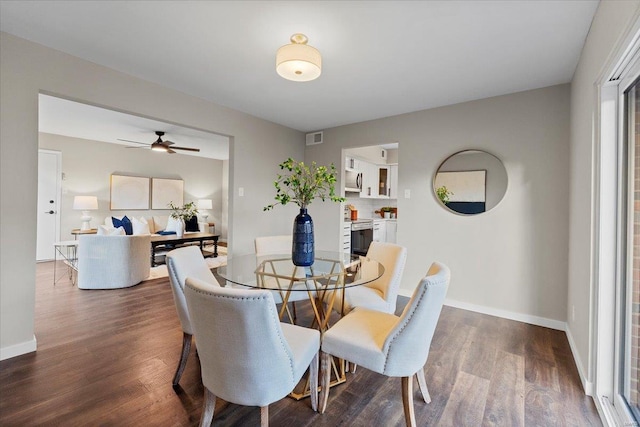 dining room featuring baseboards, visible vents, and dark wood-style flooring