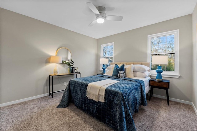 carpeted bedroom with ceiling fan and baseboards