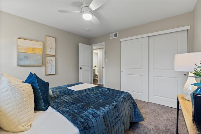 bedroom featuring carpet floors, a closet, visible vents, and ceiling fan