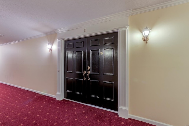 interior space with baseboards, ornamental molding, and a textured ceiling