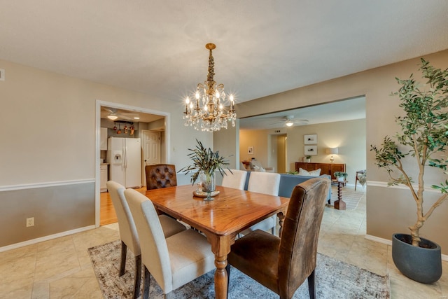 dining space featuring baseboards and a ceiling fan