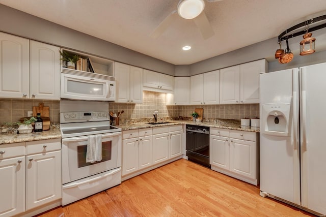 kitchen featuring white appliances, decorative backsplash, light wood-type flooring, white cabinetry, and a sink