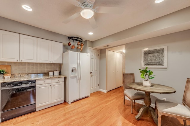 kitchen with backsplash, light wood-style flooring, white cabinetry, white fridge with ice dispenser, and dishwasher