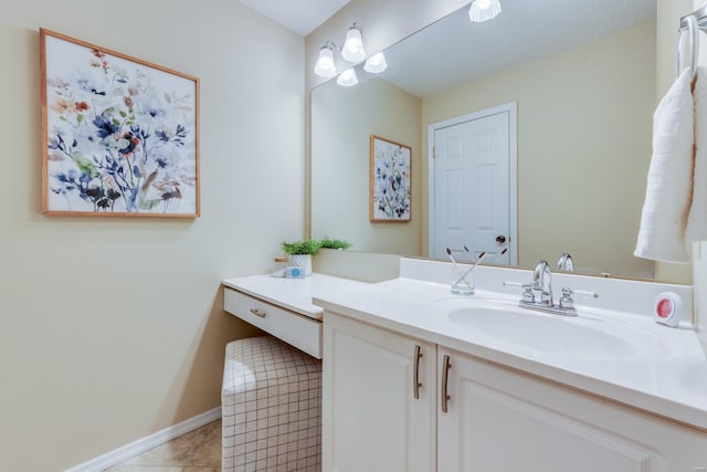 bathroom with tile patterned flooring, vanity, and baseboards