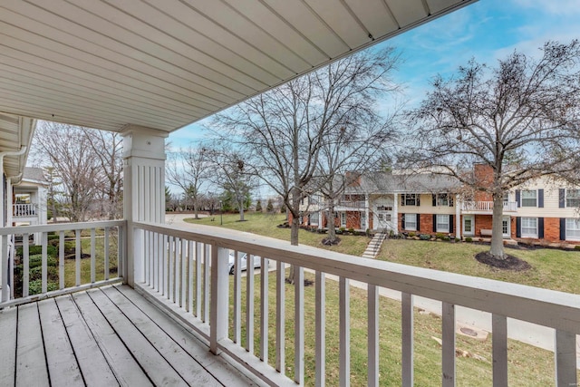 deck featuring a residential view and a yard