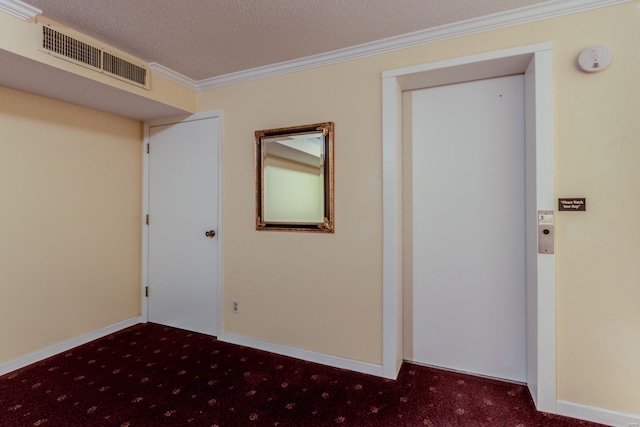 carpeted spare room with ornamental molding, visible vents, a textured ceiling, and baseboards