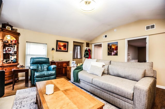 living room with visible vents, baseboards, light wood-type flooring, and lofted ceiling