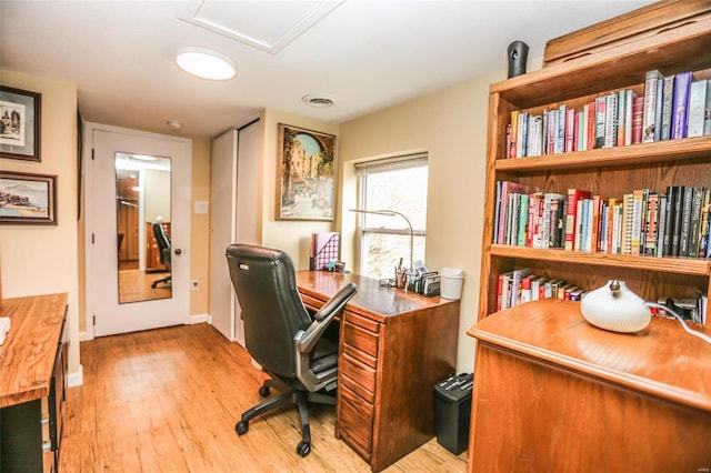 office with visible vents, baseboards, and wood finished floors