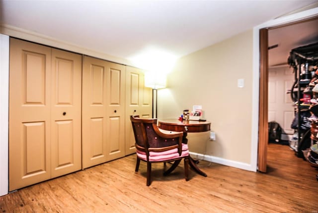 sitting room featuring baseboards and light wood finished floors