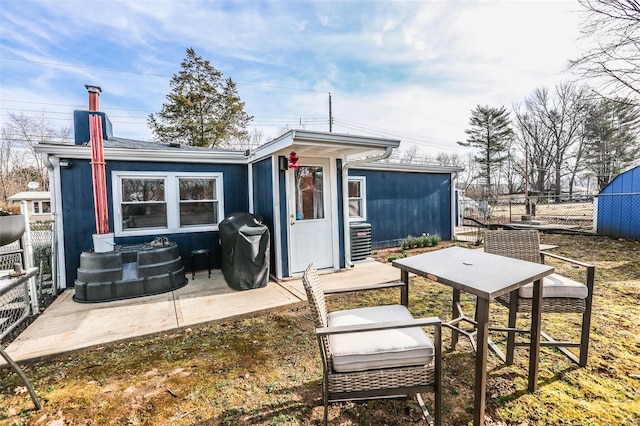 back of house featuring a patio area and fence