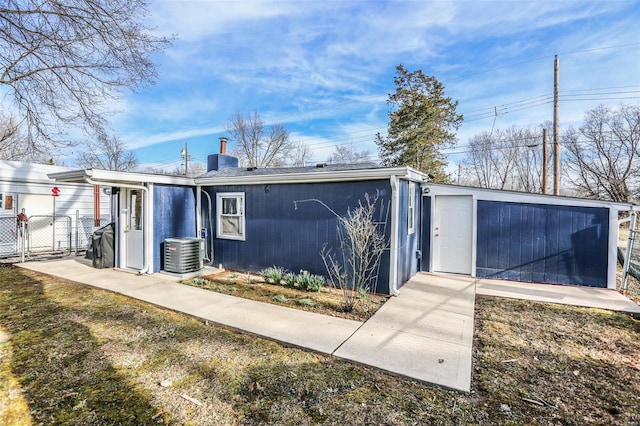 exterior space with a gate, central air condition unit, and fence