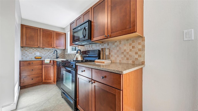 kitchen featuring light stone counters, brown cabinets, tasteful backsplash, light tile patterned flooring, and black appliances