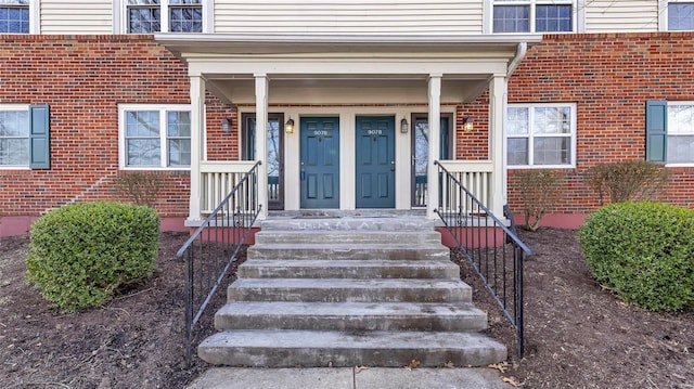 doorway to property with brick siding