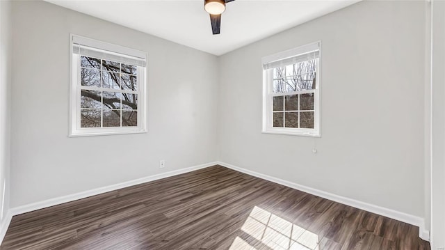 empty room with baseboards and dark wood-style flooring