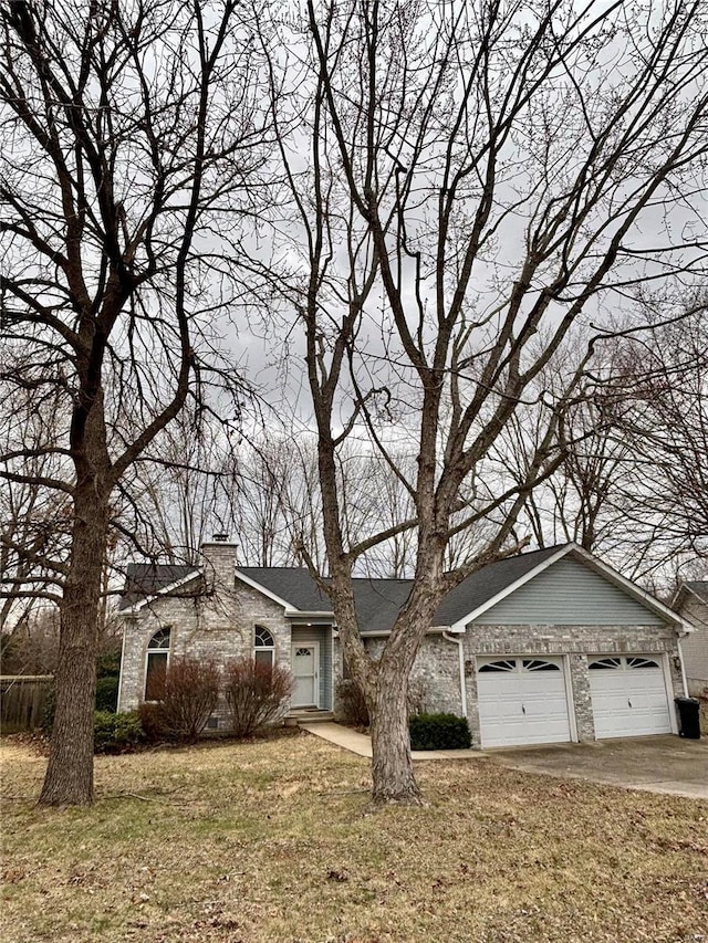 view of front facade with an attached garage, brick siding, a shingled roof, a front lawn, and a chimney