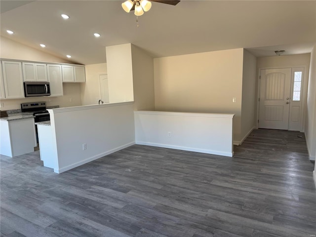 kitchen featuring dark wood finished floors, stainless steel appliances, lofted ceiling, recessed lighting, and white cabinets