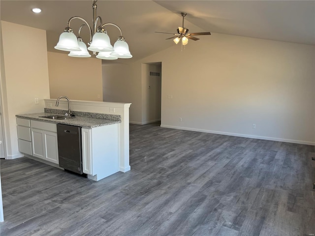 kitchen featuring pendant lighting, lofted ceiling, stainless steel dishwasher, dark wood-type flooring, and a sink