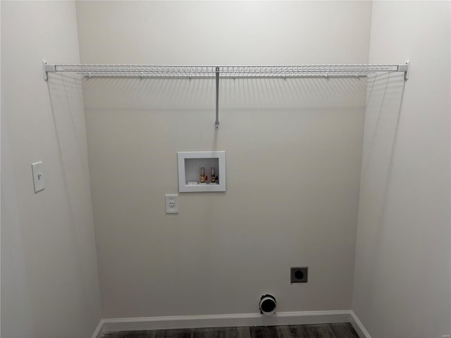 clothes washing area with hookup for a washing machine, dark wood finished floors, electric dryer hookup, and baseboards