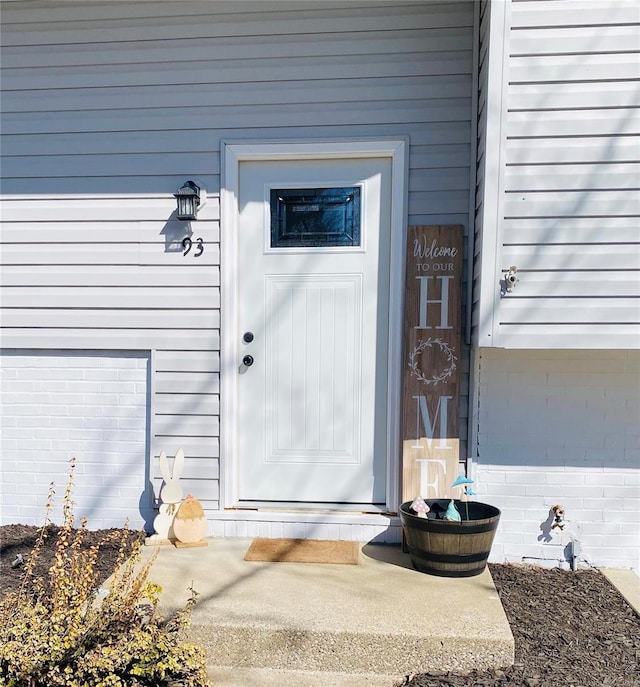 entrance to property with brick siding