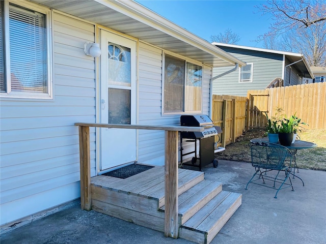 wooden terrace with fence and a grill