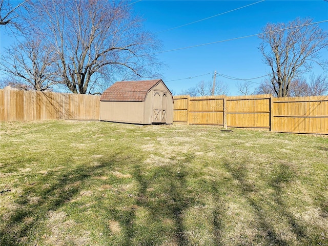 view of yard with a storage unit, a fenced backyard, and an outdoor structure