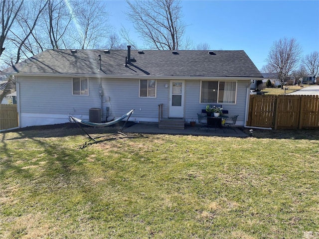 rear view of house with fence, central air condition unit, entry steps, a yard, and a patio