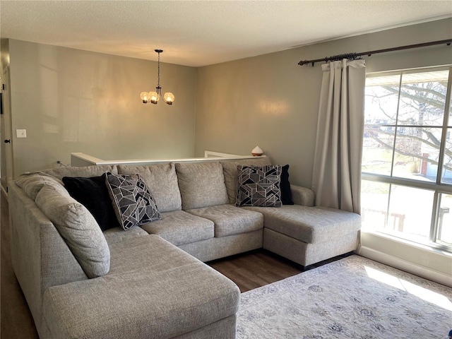 living area with a textured ceiling, an inviting chandelier, and wood finished floors