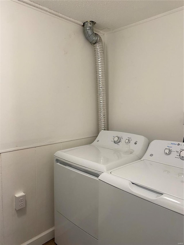 laundry area featuring laundry area, washing machine and dryer, and a textured ceiling