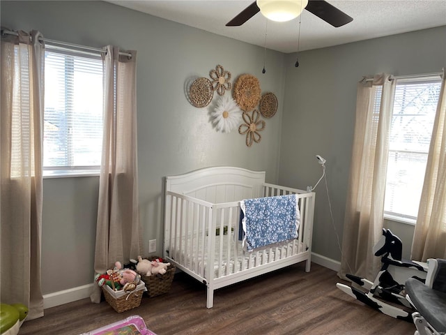 bedroom with multiple windows and wood finished floors