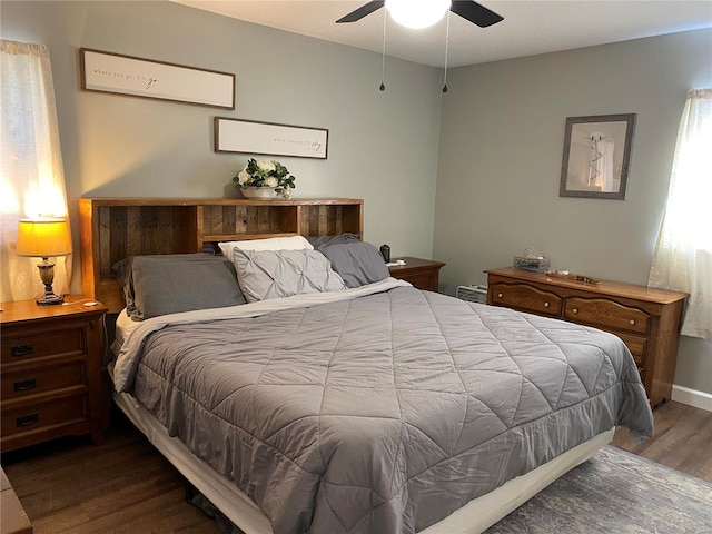 bedroom featuring baseboards, ceiling fan, and wood finished floors