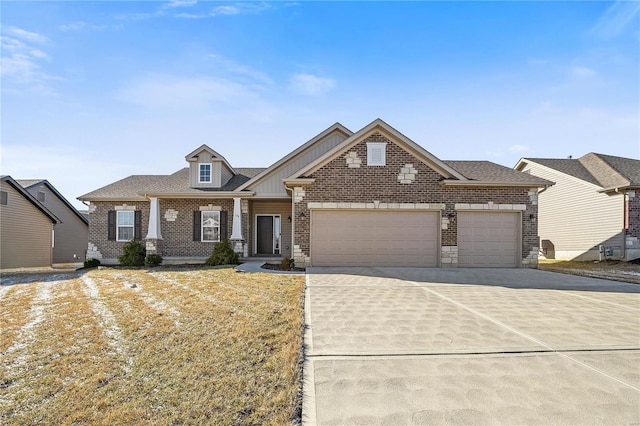 craftsman inspired home with a garage, brick siding, driveway, and a shingled roof