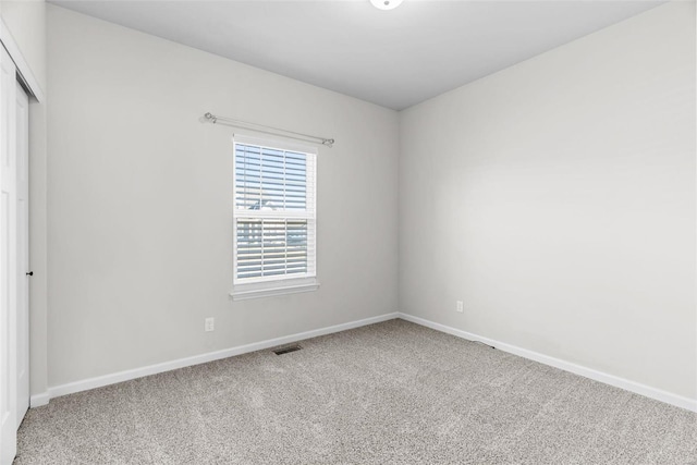 unfurnished bedroom featuring carpet floors, a closet, visible vents, and baseboards