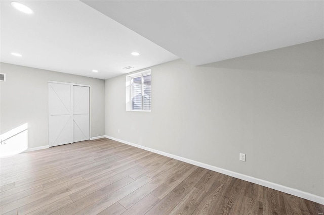 interior space featuring recessed lighting, wood finished floors, visible vents, and baseboards