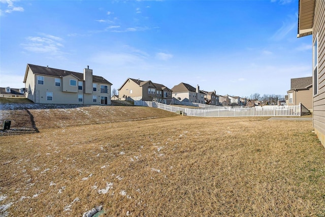 view of yard with a residential view and fence