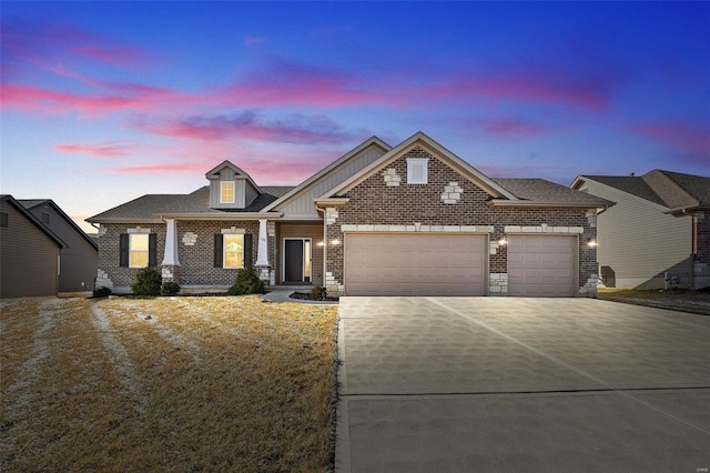 view of front of home featuring a garage, concrete driveway, and brick siding