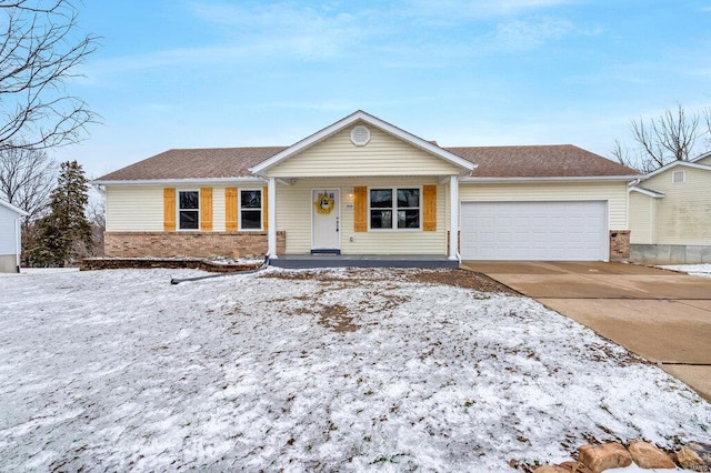 single story home featuring a garage, driveway, brick siding, and a porch