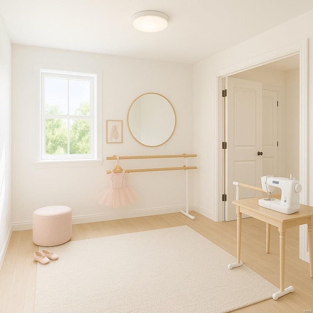 interior space featuring baseboards and wood finished floors