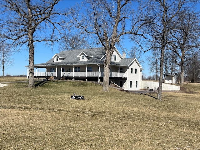 view of front of home featuring a chimney and a front lawn