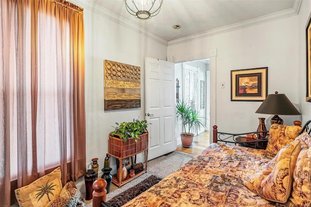 interior space with wood finished floors and crown molding