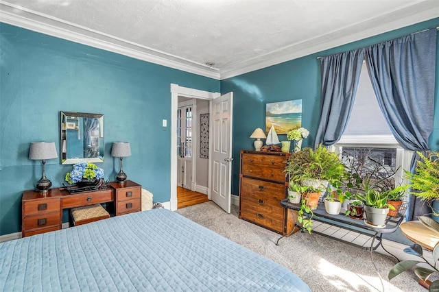 bedroom featuring carpet, a textured ceiling, baseboards, and crown molding