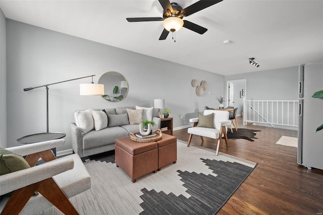 living area featuring baseboards and wood finished floors