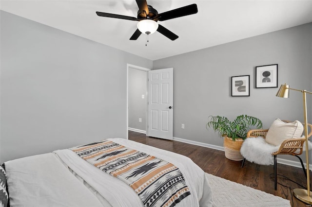 bedroom featuring wood finished floors, baseboards, and ceiling fan