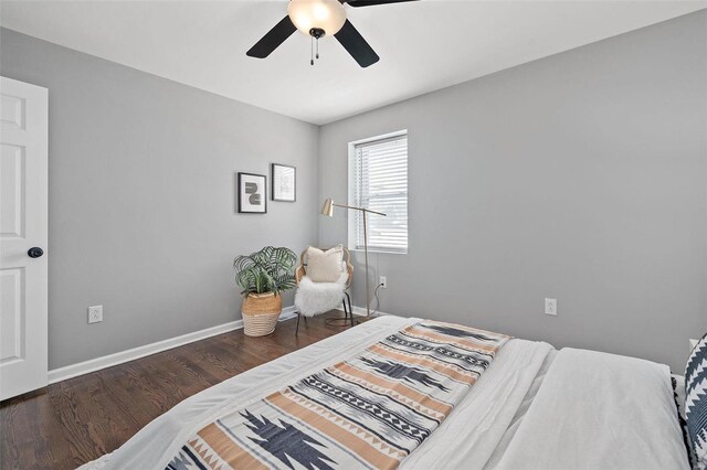 bedroom with a ceiling fan, baseboards, and wood finished floors