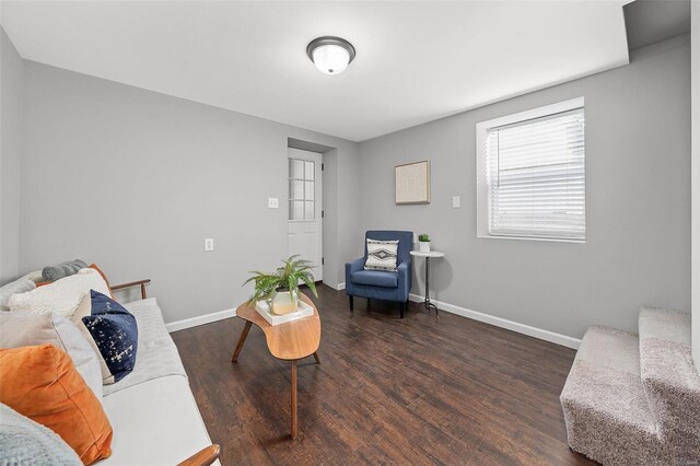 living room featuring baseboards and wood finished floors