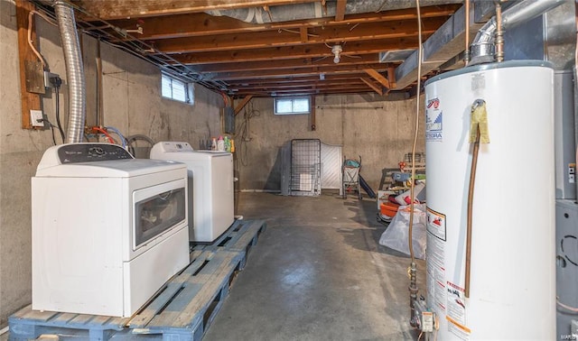 basement featuring water heater and washer and clothes dryer