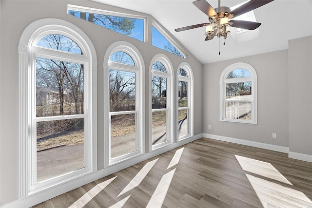 unfurnished sunroom with vaulted ceiling and ceiling fan